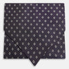 View 1 of product The Turnbull & Asser Blue Diamond Silk Cravat is a refined men's formal accessory, featuring a navy blue base with small white diamond patterns—perfectly complemented by a neatly folded, pointed-corner pocket square.