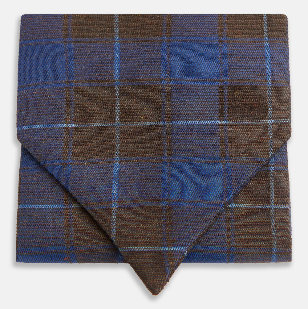 The Turnbull & Asser Blue and Brown Tartan Silk Blend Cravat is neatly folded with sharp creases and displayed on a white background.