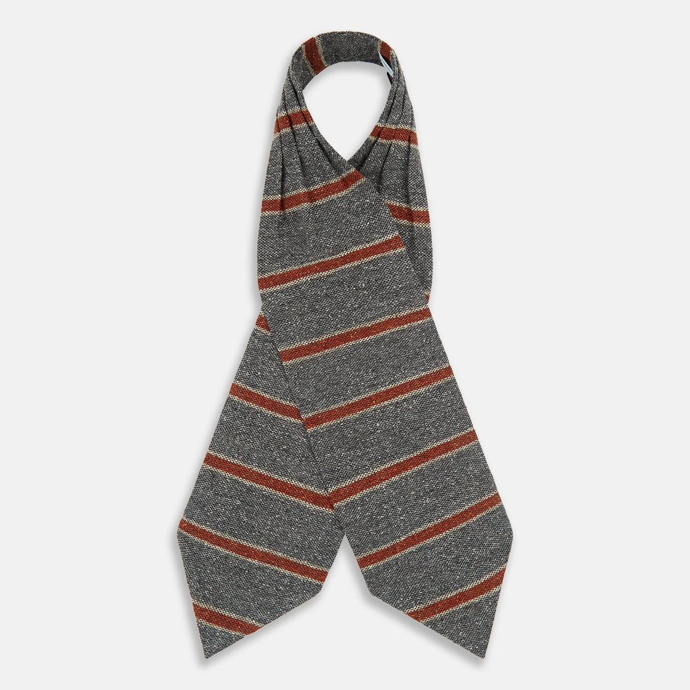 The Red Block Stripe Silk Cravat by Turnbull & Asser features gray textured fabric with two bold red-orange stripes and a pointed tip, reminiscent of handmade neckwear, shown against a white background.