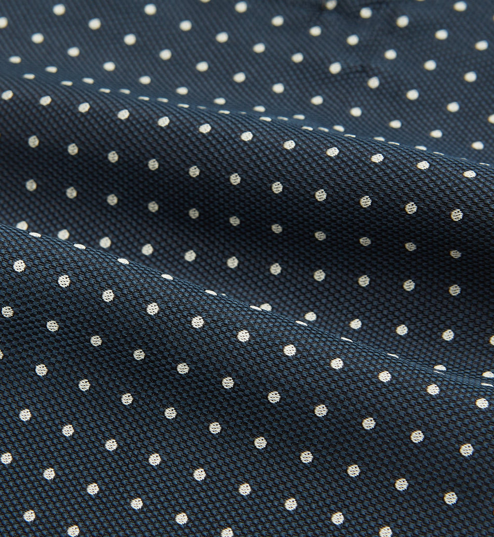 The Turnbull & Asser Navy Micro Dot Silk Cravat is a classic men's accessory, featuring subtle white polka dots—a sophisticated touch that pairs perfectly with a navy pocket square for timeless formal style.