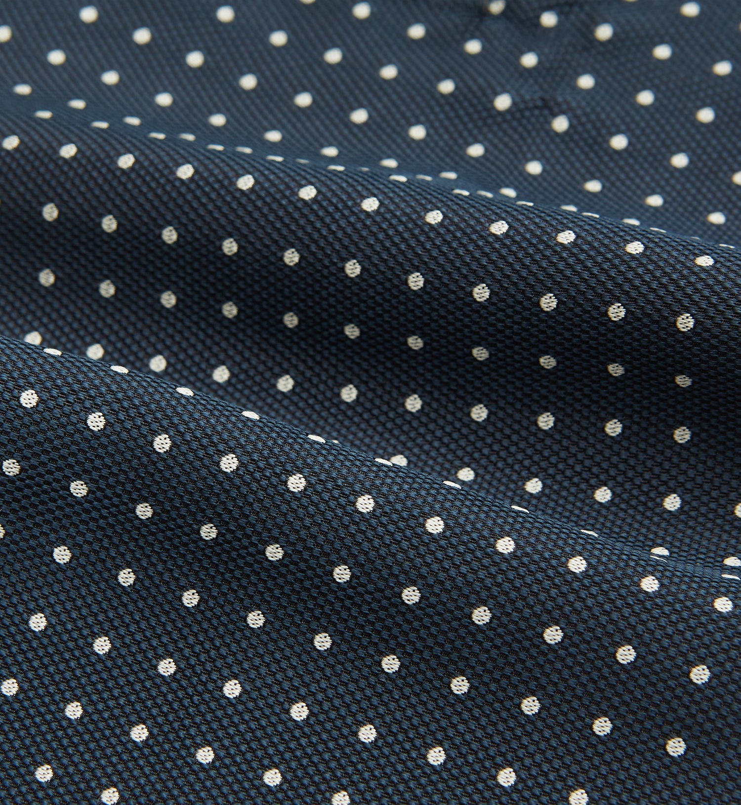 View 4 of product The Turnbull & Asser Navy Micro Dot Silk Cravat is a classic men's accessory, featuring subtle white polka dots—a sophisticated touch that pairs perfectly with a navy pocket square for timeless formal style.