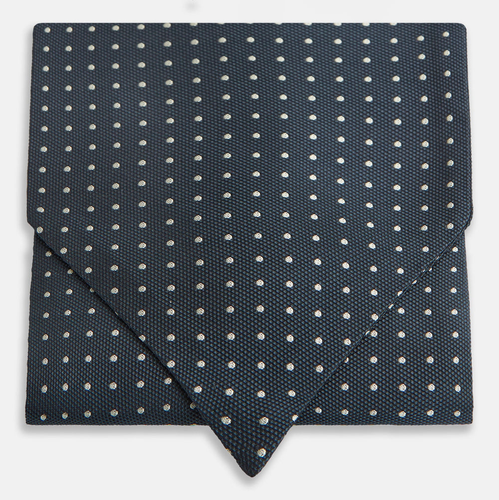 The Turnbull & Asser Navy Micro Dot Silk Cravat is a classic men's accessory, featuring subtle white polka dots—a sophisticated touch that pairs perfectly with a navy pocket square for timeless formal style.