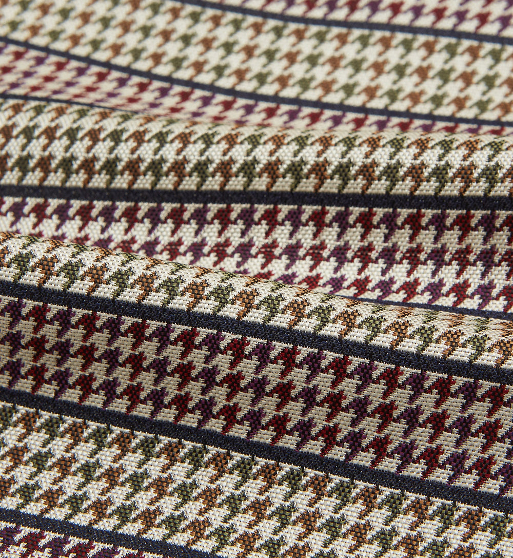 The Turnbull & Asser Brown Puppytooth Silk Cravat features a houndstooth pattern in brown, burgundy, and cream—evoking the refined elegance of a handmade accessory—displayed against a white background.