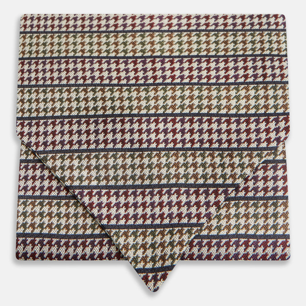 The Turnbull & Asser Brown Puppytooth Silk Cravat features a houndstooth pattern in brown, burgundy, and cream—evoking the refined elegance of a handmade accessory—displayed against a white background.
