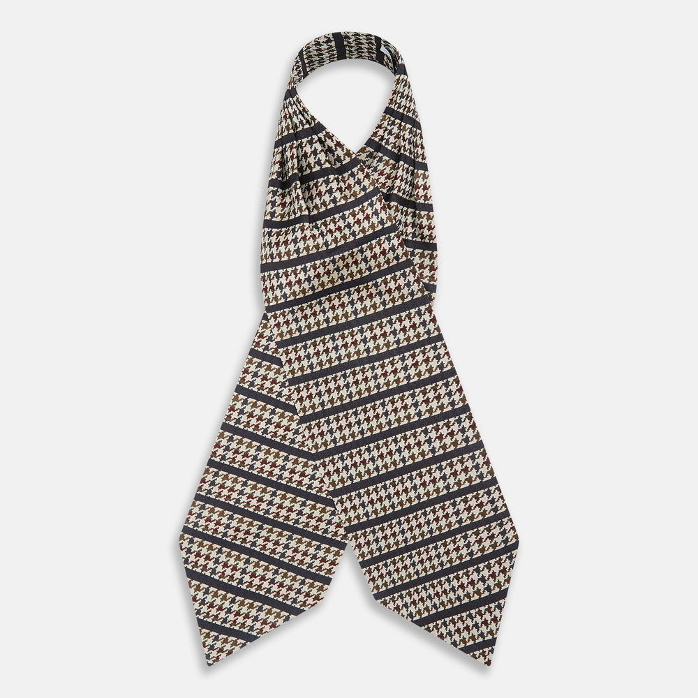 A folded pocket square with a houndstooth pattern in cream, brown, olive green, and burgundy with navy stripes—ideal for pairing with the Turnbull & Asser Brown Houndstooth Silk Cravat.