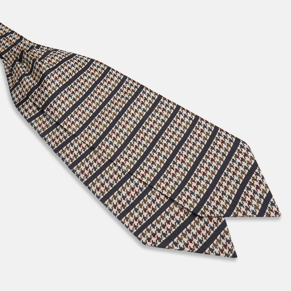 A folded pocket square with a houndstooth pattern in cream, brown, olive green, and burgundy with navy stripes—ideal for pairing with the Turnbull & Asser Brown Houndstooth Silk Cravat.