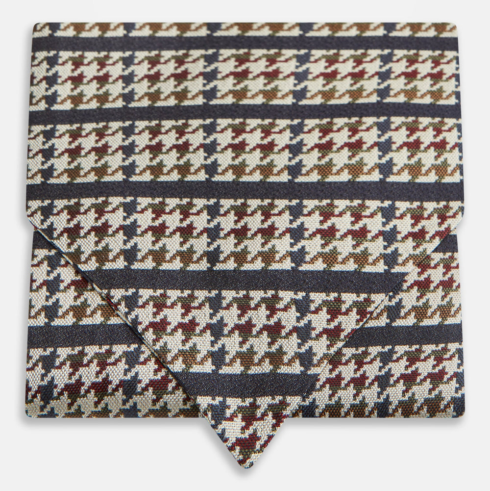 A folded pocket square with a houndstooth pattern in cream, brown, olive green, and burgundy with navy stripes—ideal for pairing with the Turnbull & Asser Brown Houndstooth Silk Cravat.