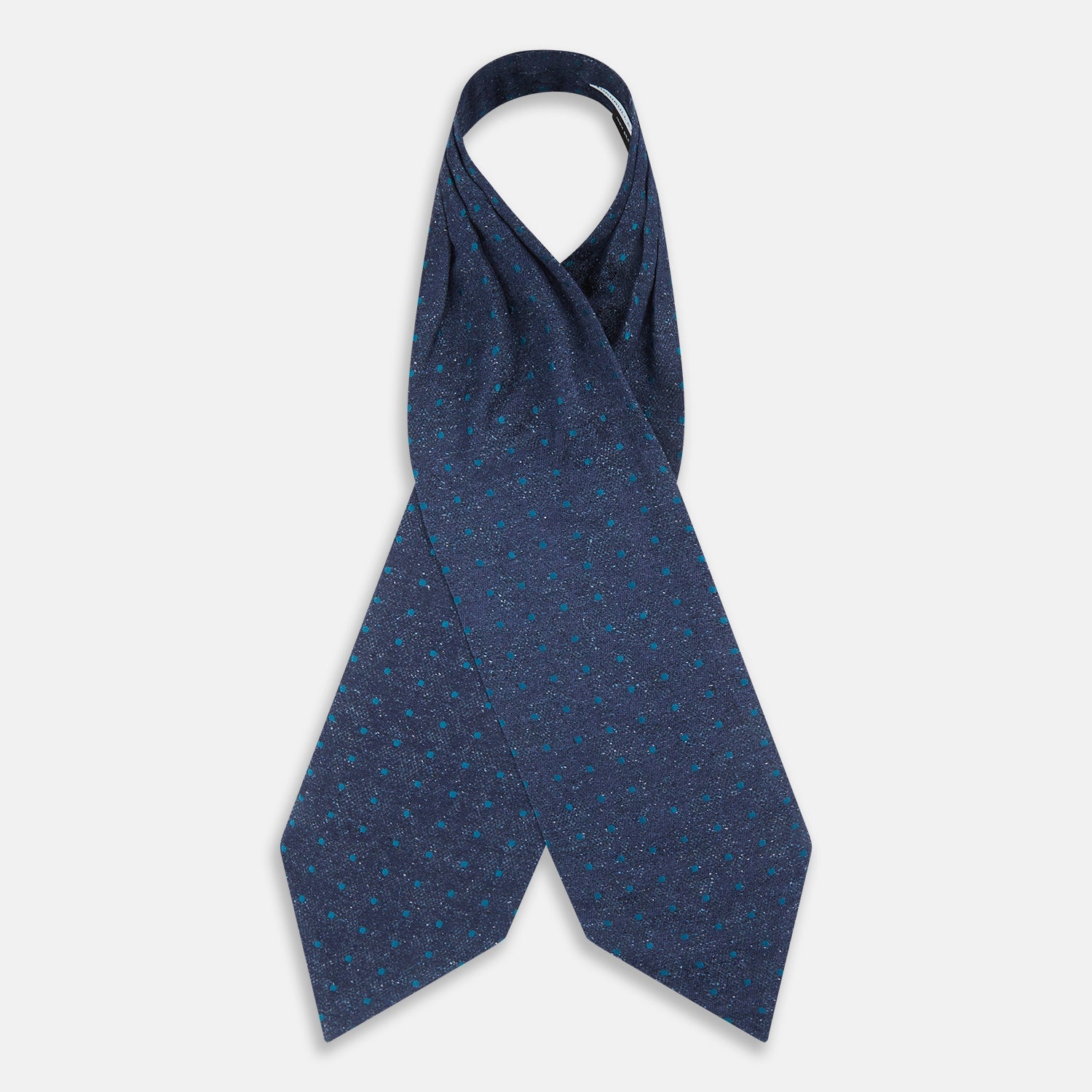 View 2 of product The Teal Micro Dot Silk Cravat by Turnbull & Asser is a formal accessory in textured dark blue silk, with small turquoise polka dots and a pointed edge at the bottom.