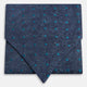 The Teal Micro Dot Silk Cravat by Turnbull & Asser is a formal accessory in textured dark blue silk, with small turquoise polka dots and a pointed edge at the bottom.