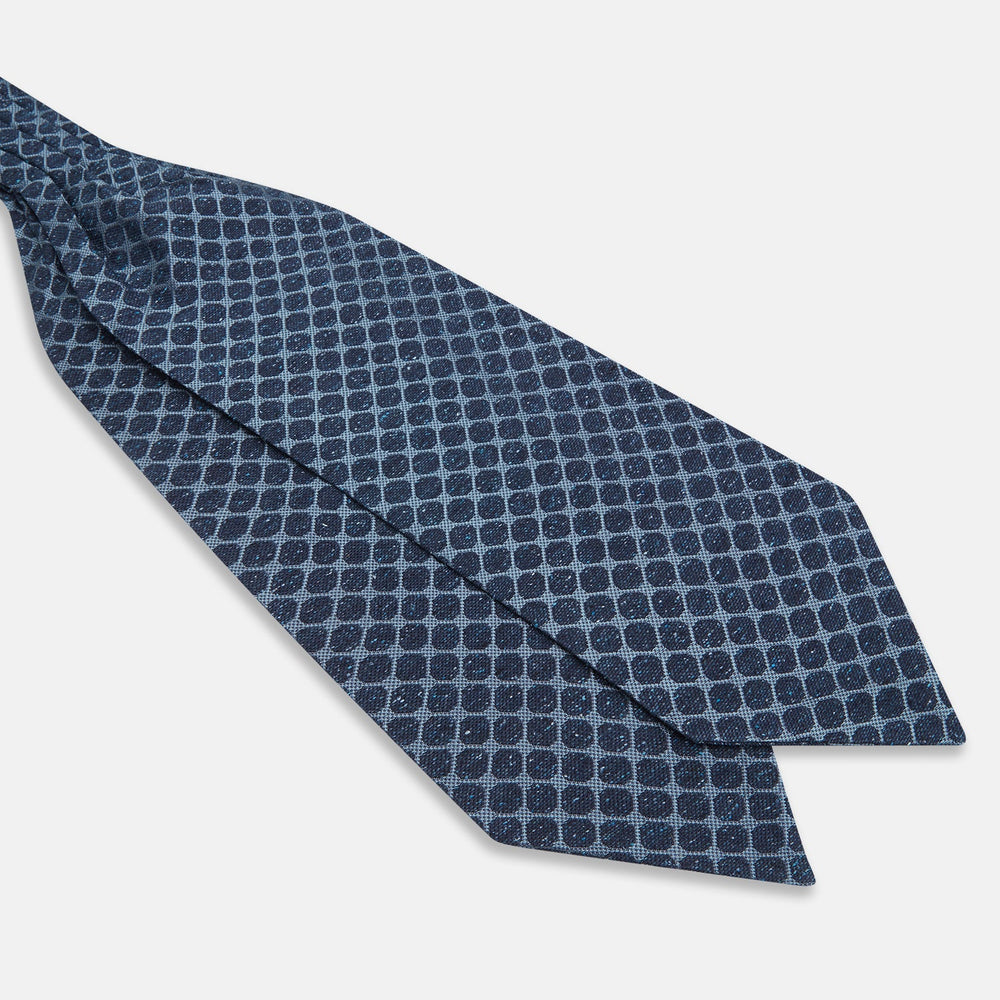 The Turnbull & Asser Navy Grid Silk Cravat features a textured hexagonal grid in dark and light blue on white—a refined, formal accessory perfect for any occasion.