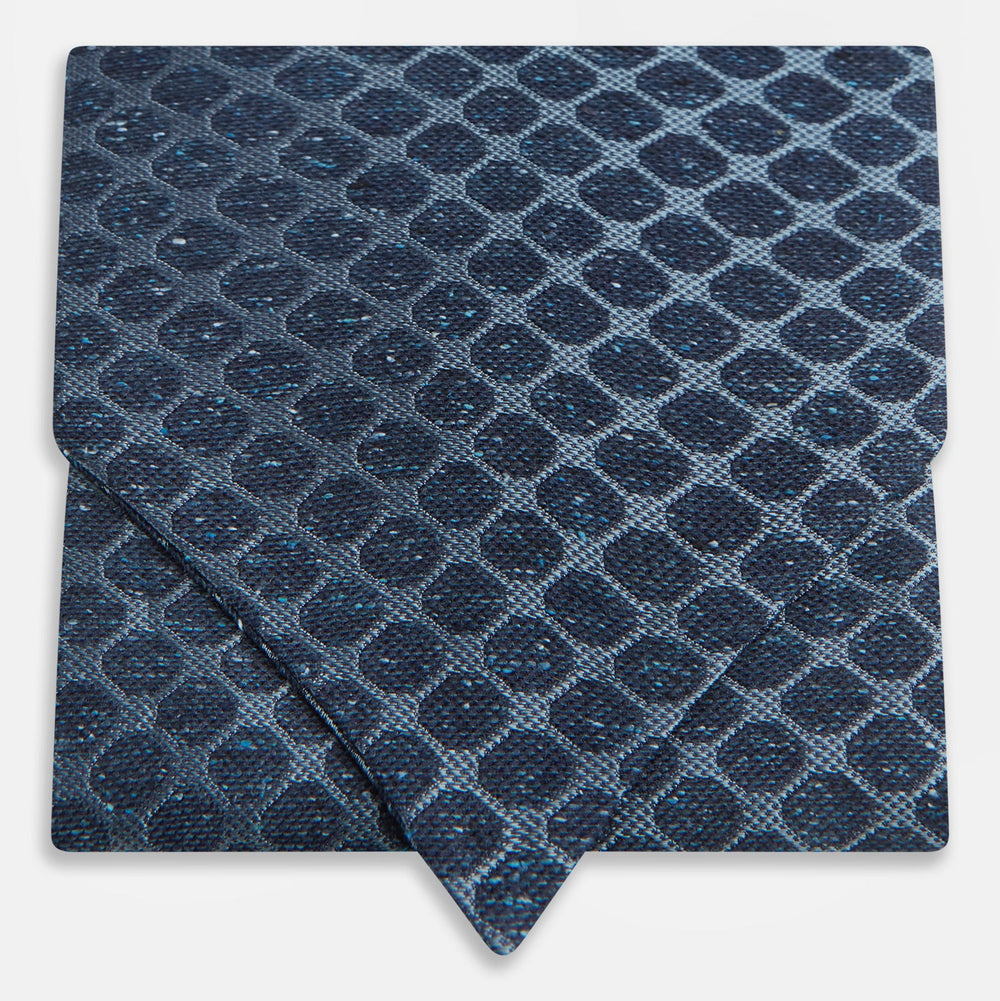 The Turnbull & Asser Navy Grid Silk Cravat features a textured hexagonal grid in dark and light blue on white—a refined, formal accessory perfect for any occasion.