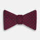 The Turnbull & Asser Green and Magenta Spot Silk Bow Tie, shown on a plain white background, features small, evenly spaced spots—making it an ideal accessory for elevating smart outfits.