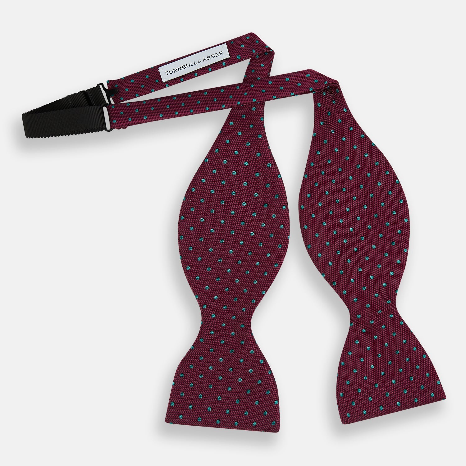 View 2 of product The Turnbull & Asser Green and Magenta Spot Silk Bow Tie, shown on a plain white background, features small, evenly spaced spots—making it an ideal accessory for elevating smart outfits.