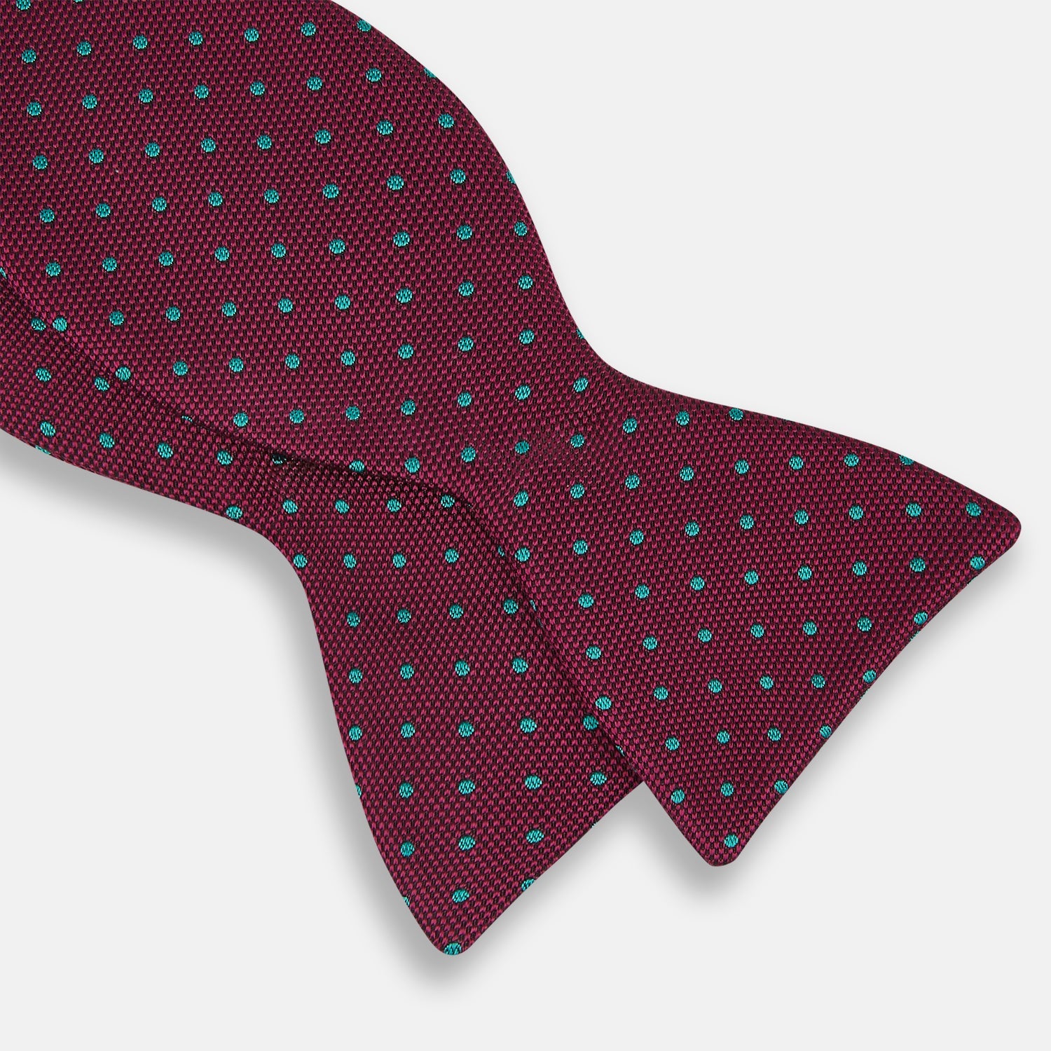 View 3 of product The Turnbull & Asser Green and Magenta Spot Silk Bow Tie, shown on a plain white background, features small, evenly spaced spots—making it an ideal accessory for elevating smart outfits.
