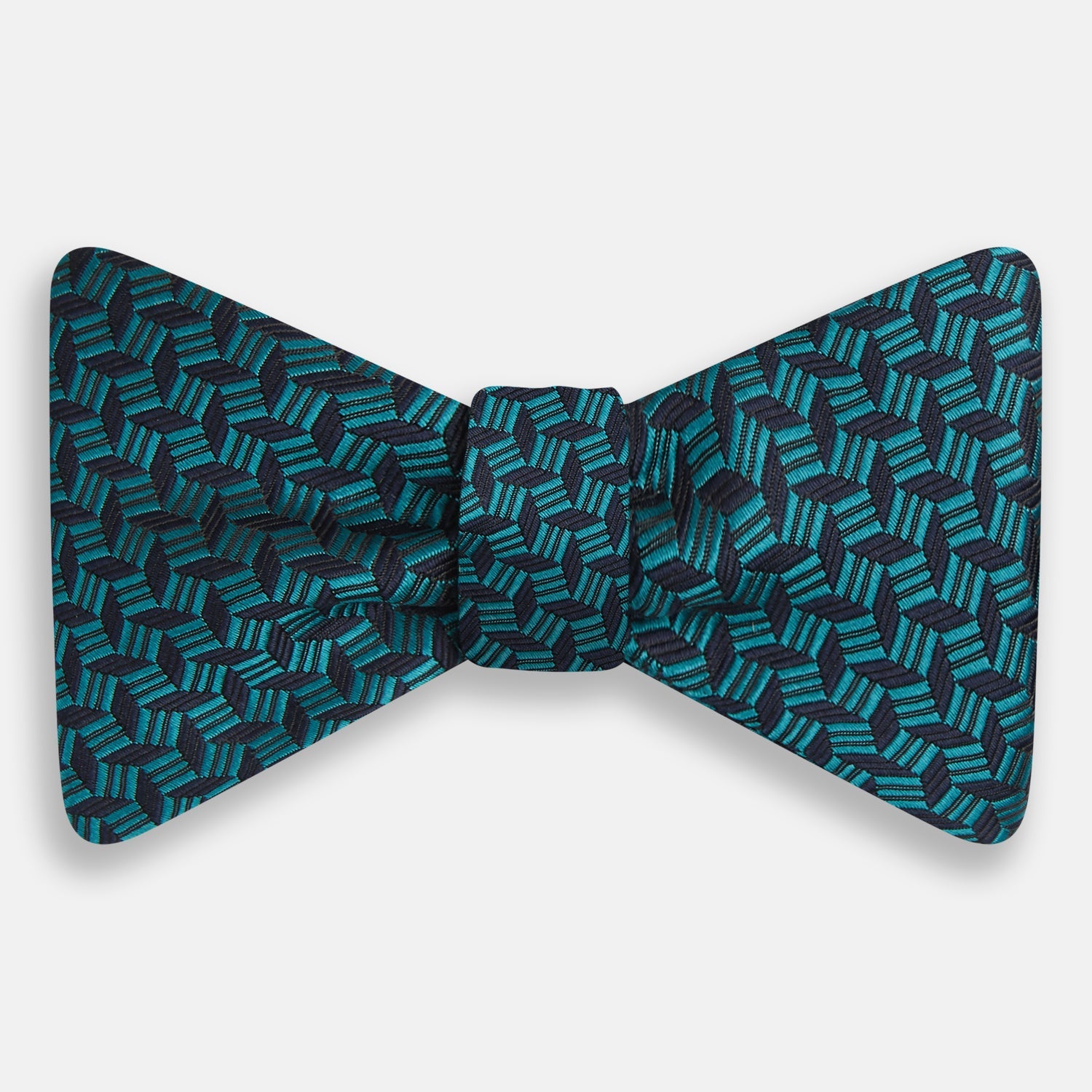 View 1 of product Turnbull & Asser's Turquoise Geometric Silk Bow Tie showcases British elegance with its teal and black cube pattern, set against a white background.