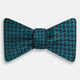 Turnbull & Asser's Turquoise Geometric Silk Bow Tie showcases British elegance with its teal and black cube pattern, set against a white background.