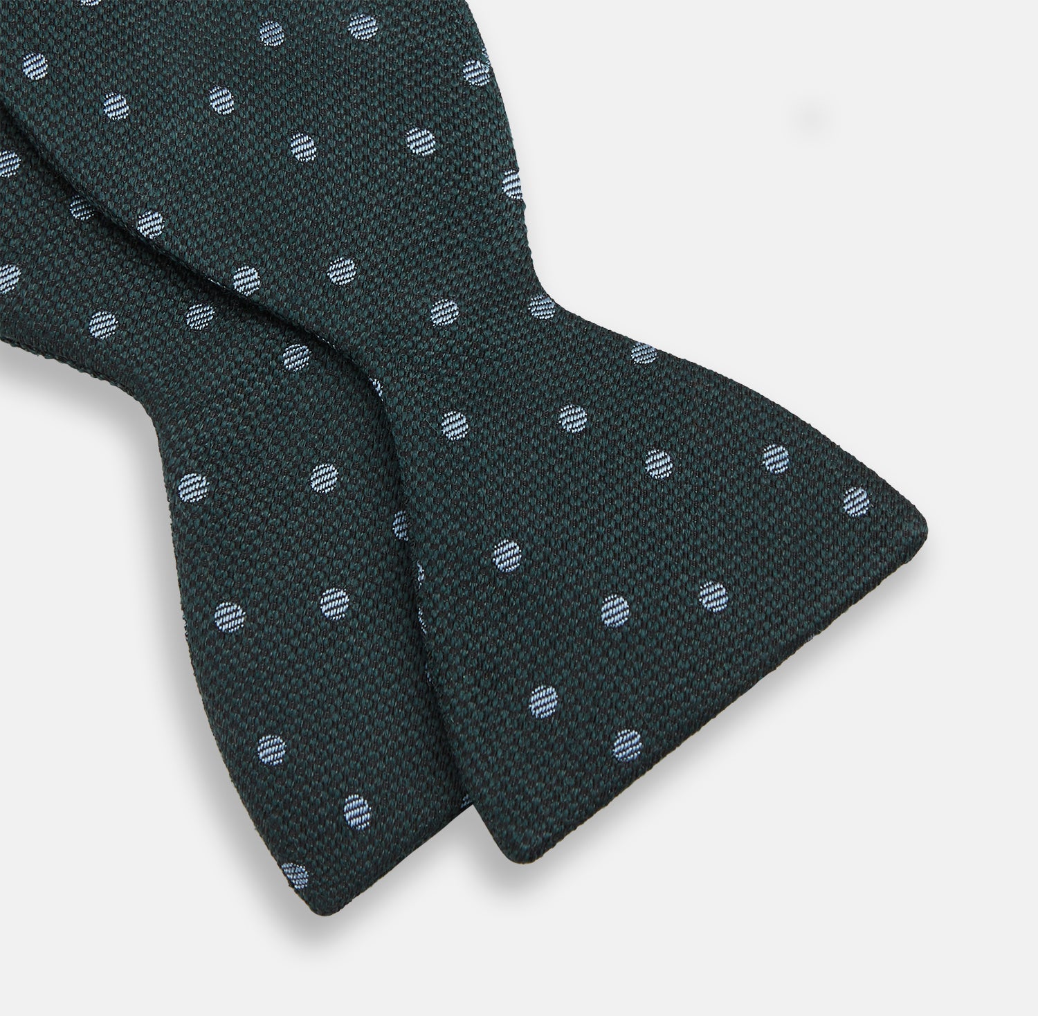 View 3 of product The Turnbull & Asser Pale Blue and Green Micro Dot Silk Bow Tie features a refined micro dot pattern, blending pale blue and green hues for a touch of British elegance, shown on a white background.
