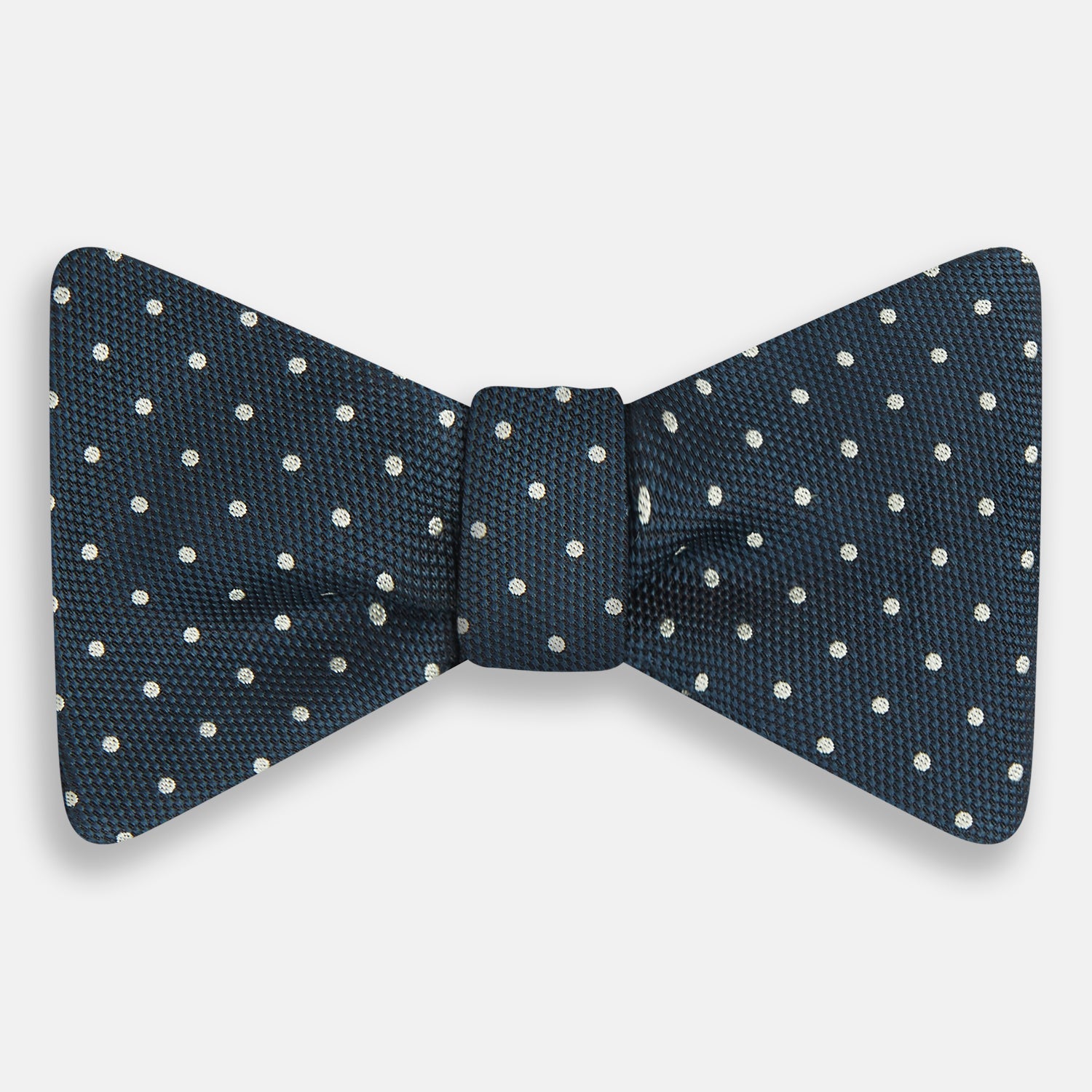 View 1 of product The Turnbull & Asser Navy Micro Dot Silk Bow Tie, shown on a white background, embodies British sophistication and classic formal style.