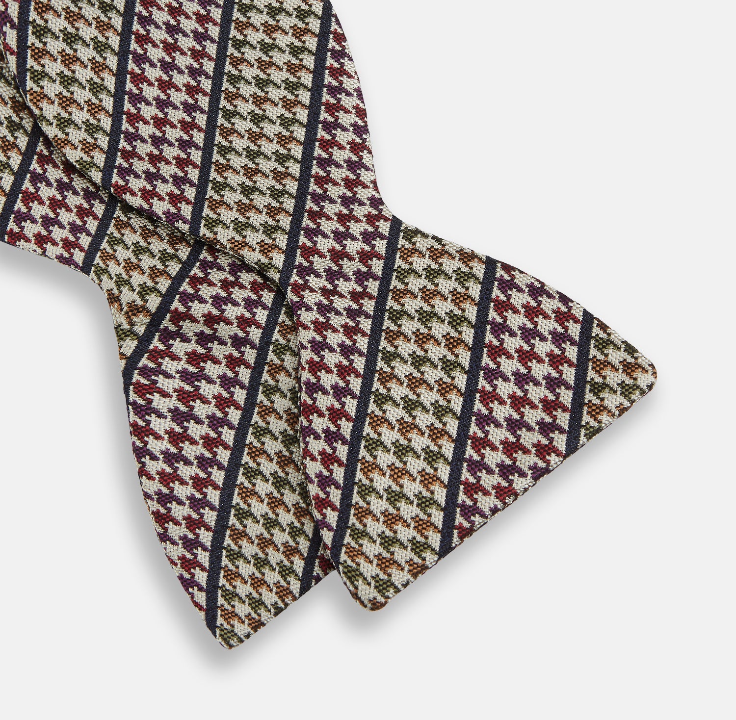 View 3 of product The Brown Puppytooth Stripe Silk Bow Tie by Turnbull & Asser features a houndstooth pattern in brown, beige, and burgundy with navy stripes—an elegant choice for formal occasions. Shown on a crisp white background.