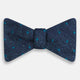 The Turnbull & Asser Teal Micro Dot Silk Bow Tie features textured navy blue silk with small teal dots, showcasing British elegance against a white background.