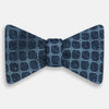 View 1 of product The Navy Grid Silk Bow Tie from Turnbull & Asser features a geometric dark blue square pattern on lighter silk—an ideal choice for bringing British elegance and refined style to any formal occasion.