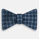 The Navy Grid Silk Bow Tie from Turnbull & Asser features a geometric dark blue square pattern on lighter silk—an ideal choice for bringing British elegance and refined style to any formal occasion.