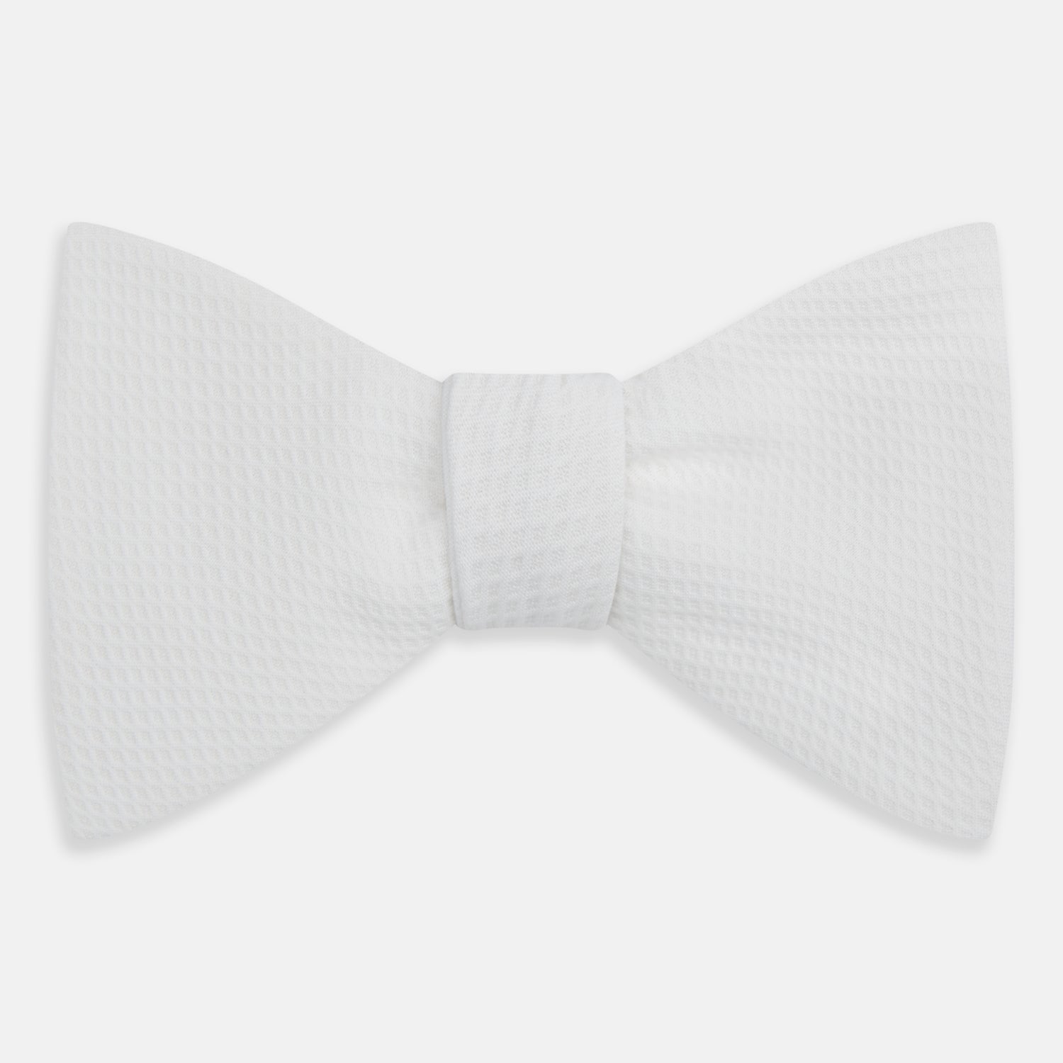 View 1 of product The Turnbull & Asser White Marcella Bow Tie features a classic shape and textured finish, ideal for formal occasions and elegantly presented against a plain white background.