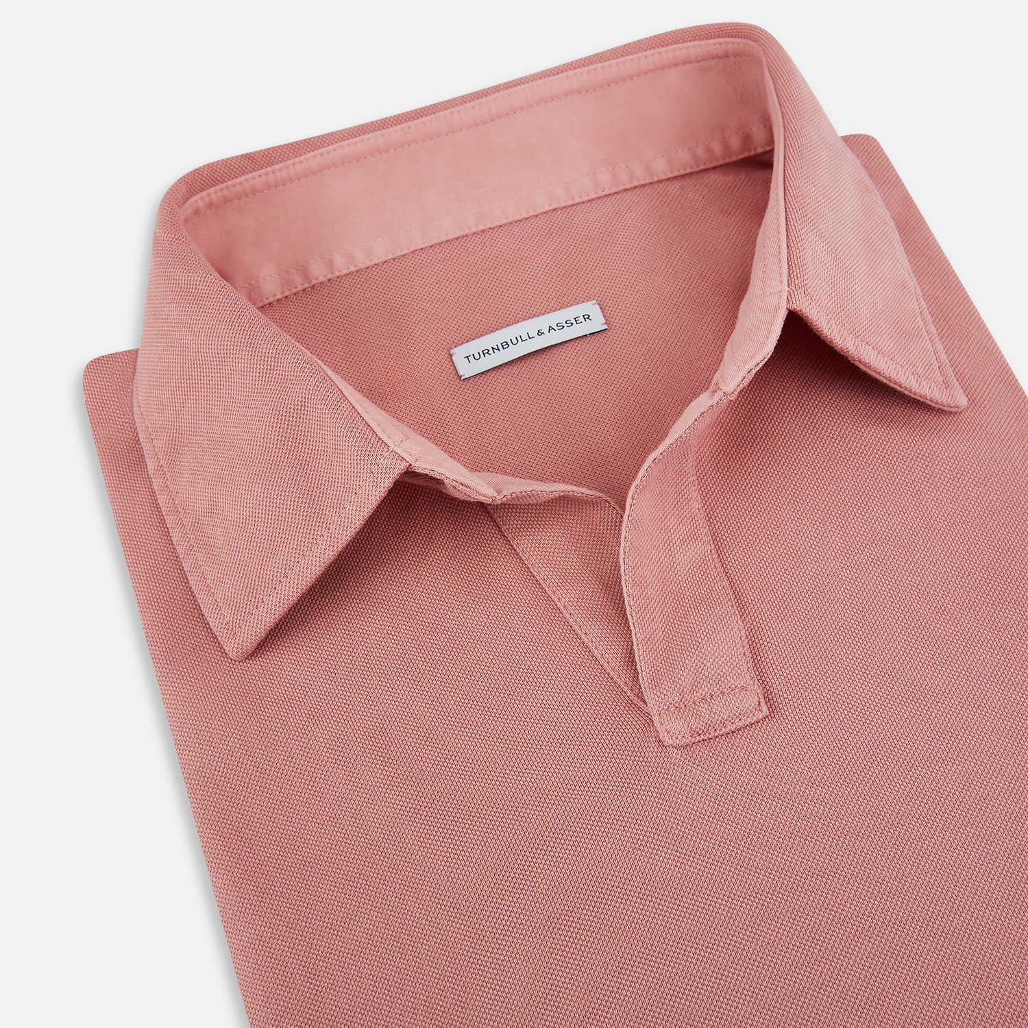 View 2 of product A Turnbull & Asser Red Rugby Polo Shirt with long sleeves, a collared neckline, v-neck opening, and no buttons is laid flat on a white background.