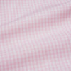 View 5 of product The Pink Windowpane Check Mayfair Shirt by Turnbull & Asser features a light pink, long-sleeve design with subtle windowpane checks, button-down front, and soft organic cotton, shown against a white background.