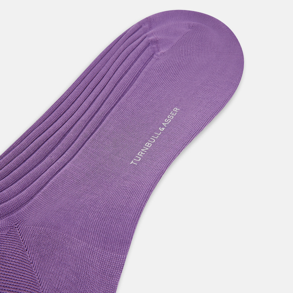 The Turnbull & Asser Violet Long Sock, crafted from mercerised Egyptian cotton, is shown in side profile against a white background, highlighting its knee-high length and ribbed texture.