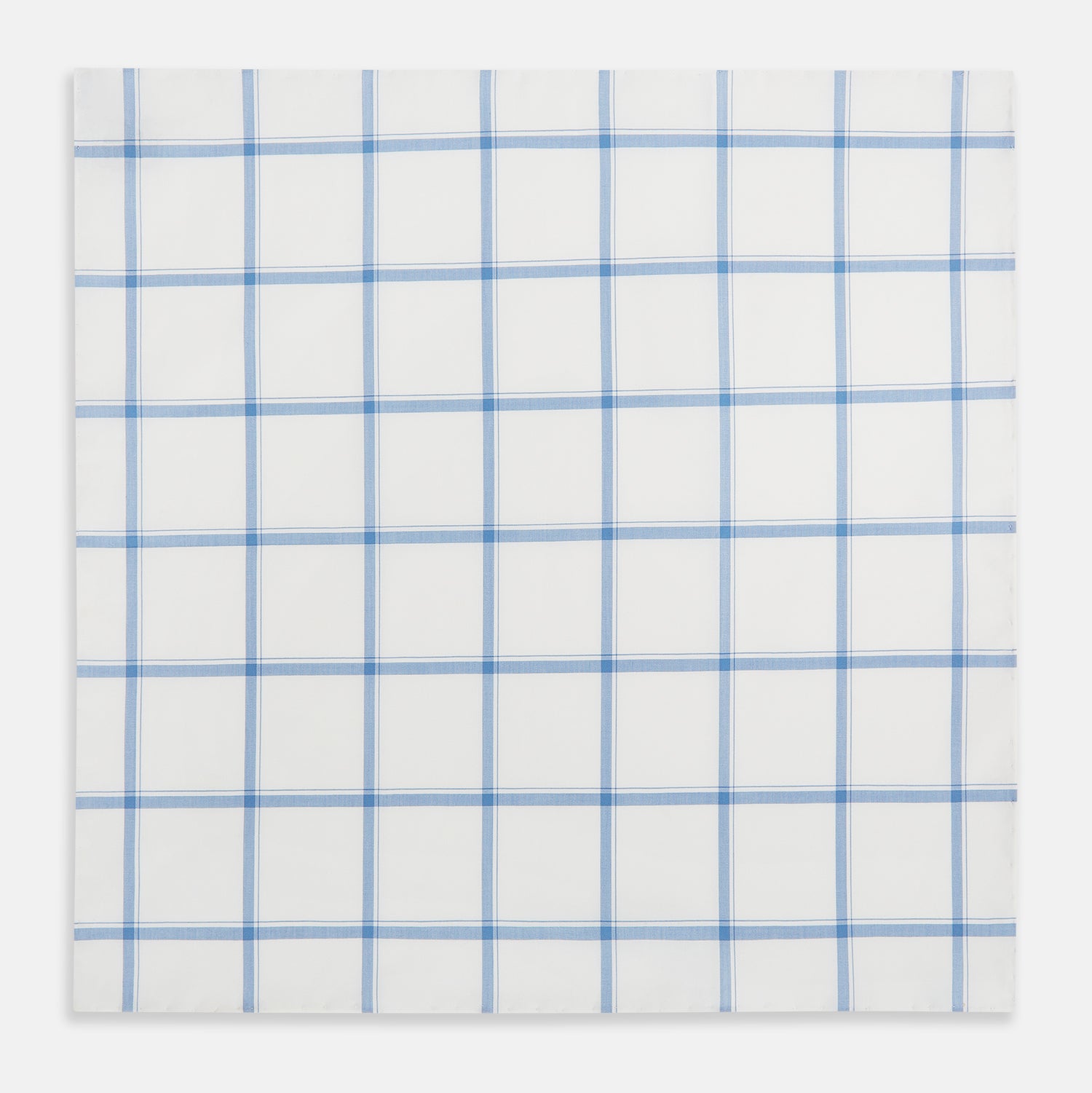 View 2 of product The Turnbull & Asser Colony Blue Grid Check Hand-Rolled Handkerchief features a white base with intersecting light and dark blue plaid lines forming squares, shown folded on a plain white background.