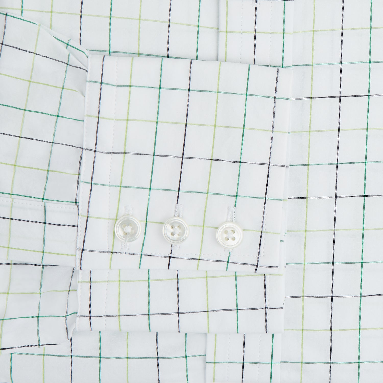 View 4 of product The Turnbull & Asser Dark Green Grid Check Mayfair Shirt features a white base with blue and dark green checks, a classic T&A collar, buttoned cuffs, and a Mayfair fit. The long-sleeve shirt is shown laid flat on a white background.
