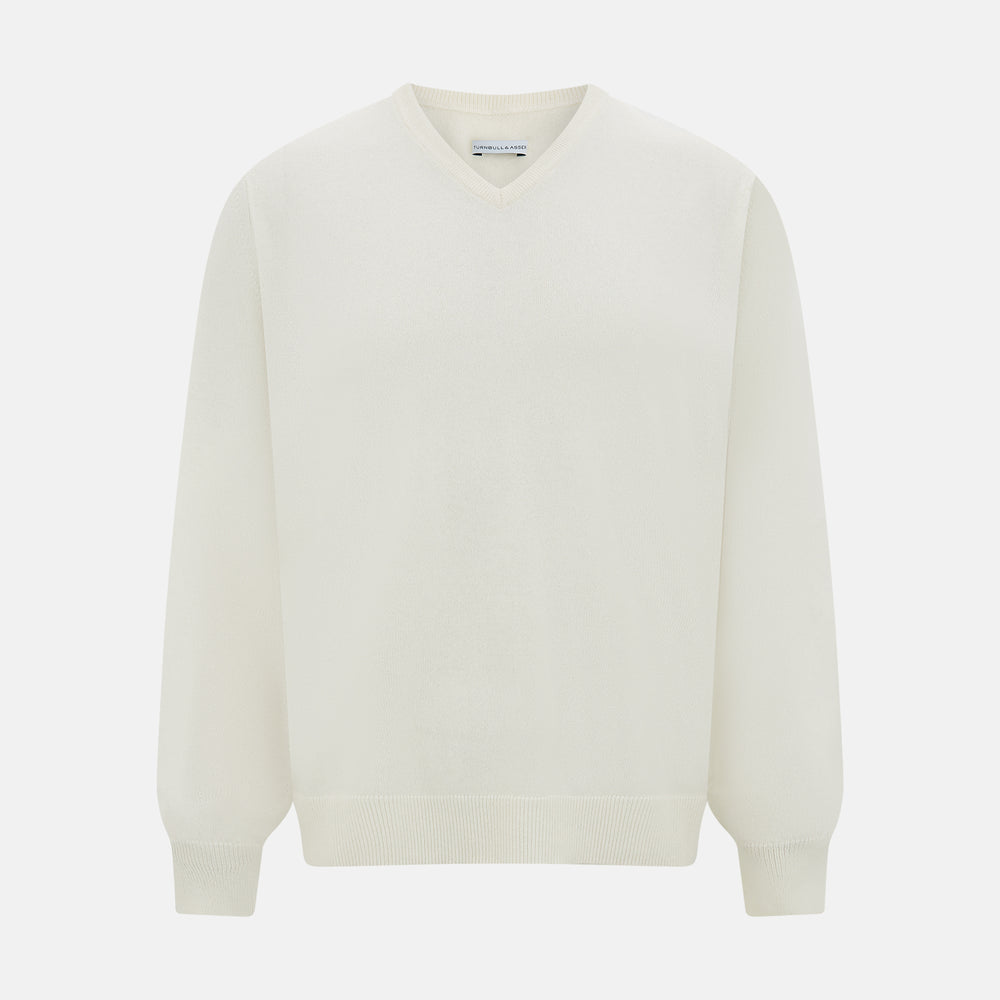 The Turnbull & Asser Ivory Cashmere V-neck Jumper features long sleeves with ribbed cuffs and hem, showcasing timeless knitwear style against a white background.