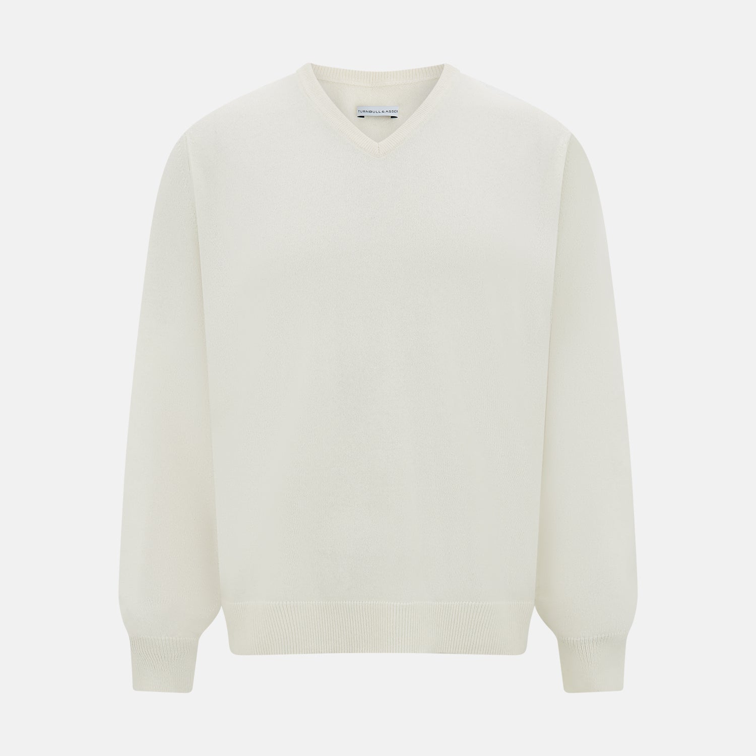 View 1 of product The Turnbull & Asser Ivory Cashmere V-neck Jumper features long sleeves with ribbed cuffs and hem, showcasing timeless knitwear style against a white background.