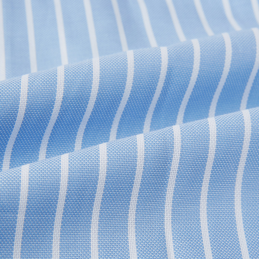 The Turnbull & Asser White and Blue Stripe Quarzo Nightshirt features long sleeves, a collar, button-up front, chest pocket, and mid-length hem—a classic men's striped sleepwear piece.