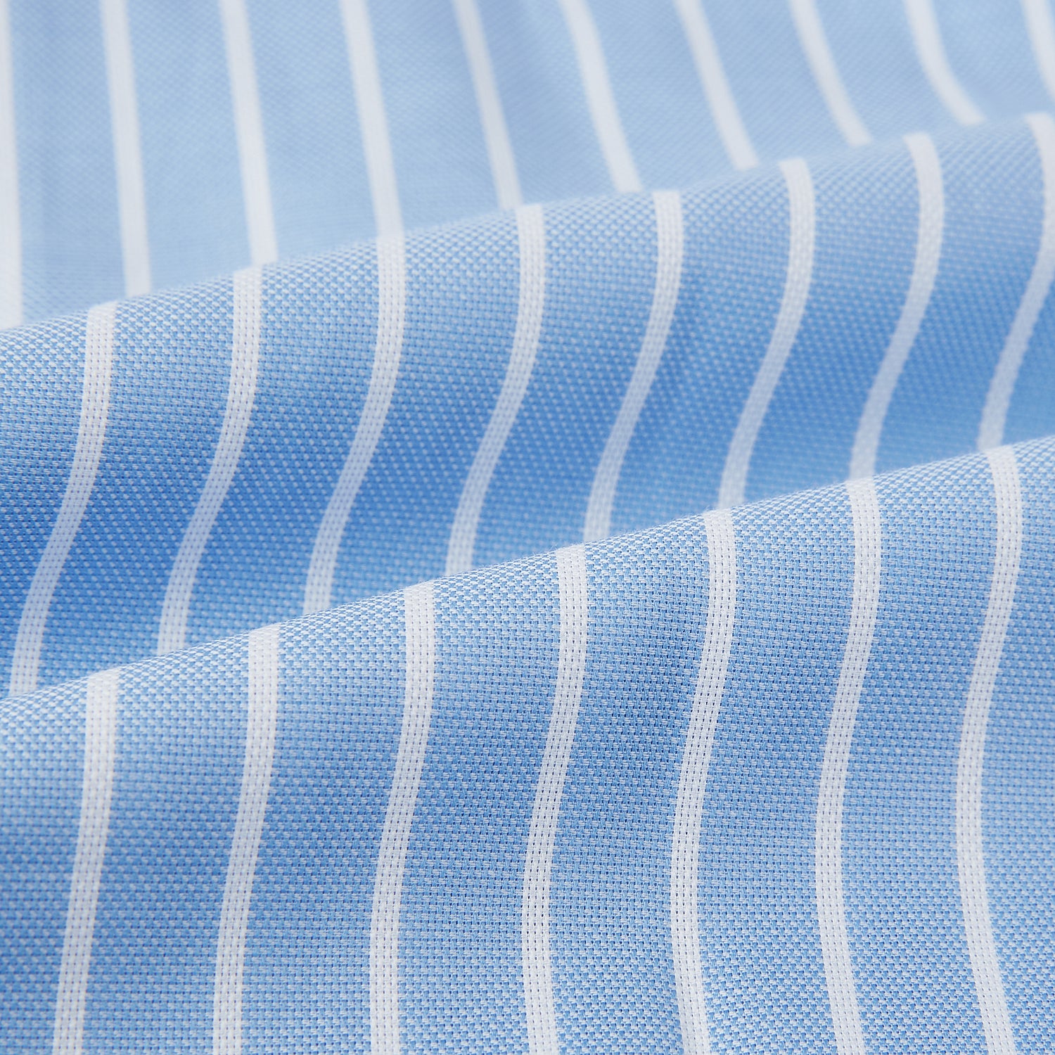 View 5 of product The Turnbull & Asser White and Blue Stripe Quarzo Nightshirt features long sleeves, a collar, button-up front, chest pocket, and mid-length hem—a classic men's striped sleepwear piece.