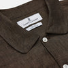 View 3 of product The Turnbull & Asser Chocolate Brown Linen Holiday Fit Fellows Shirt, featuring long sleeves, a classic collar, and white buttons, is displayed flat on a white background—ideal for effortless summer style.