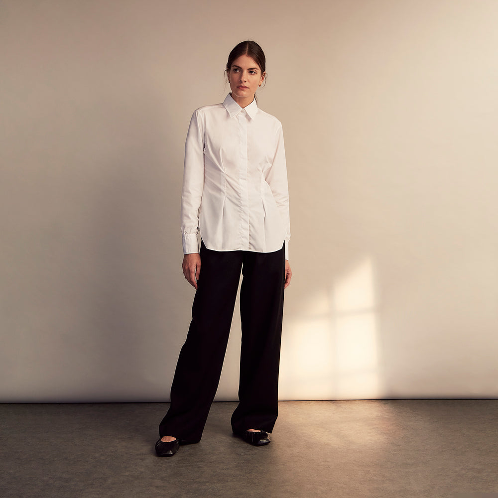 The White Cotton Tailored Bianca Shirt by Turnbull & Asser features a pointed collar and button cuffs, crafted from soft organic cotton and displayed flat on a white background for timeless elegance.