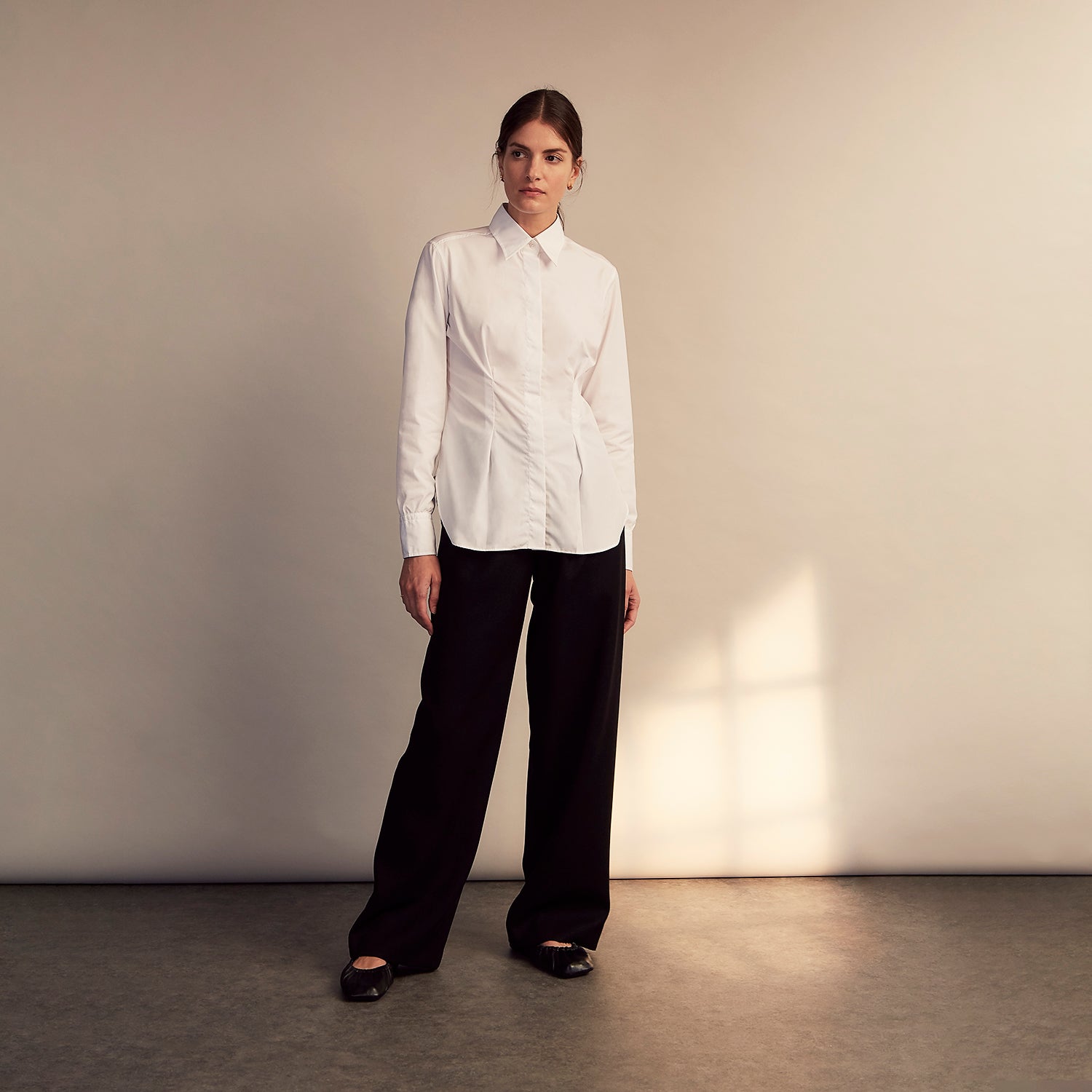View 5 of product The White Cotton Tailored Bianca Shirt by Turnbull & Asser features a pointed collar and button cuffs, crafted from soft organic cotton and displayed flat on a white background for timeless elegance.
