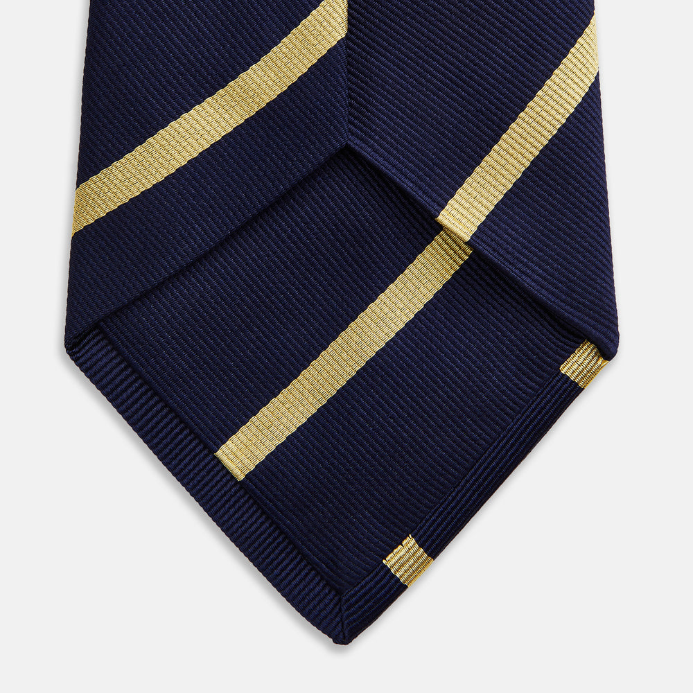 The Turnbull & Asser BLAZER STRIPE NAVY LEO TIE features classic navy with diagonal yellow stripes—an essential accessory to elevate any smart outfit.