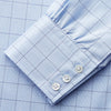 View 4 of product The Blue Prince of Wales Check Mayfair Shirt by Turnbull & Asser features a light blue check pattern, white buttons, and a classic collar. Crafted from premium Italian cotton, it is displayed on a plain white background.