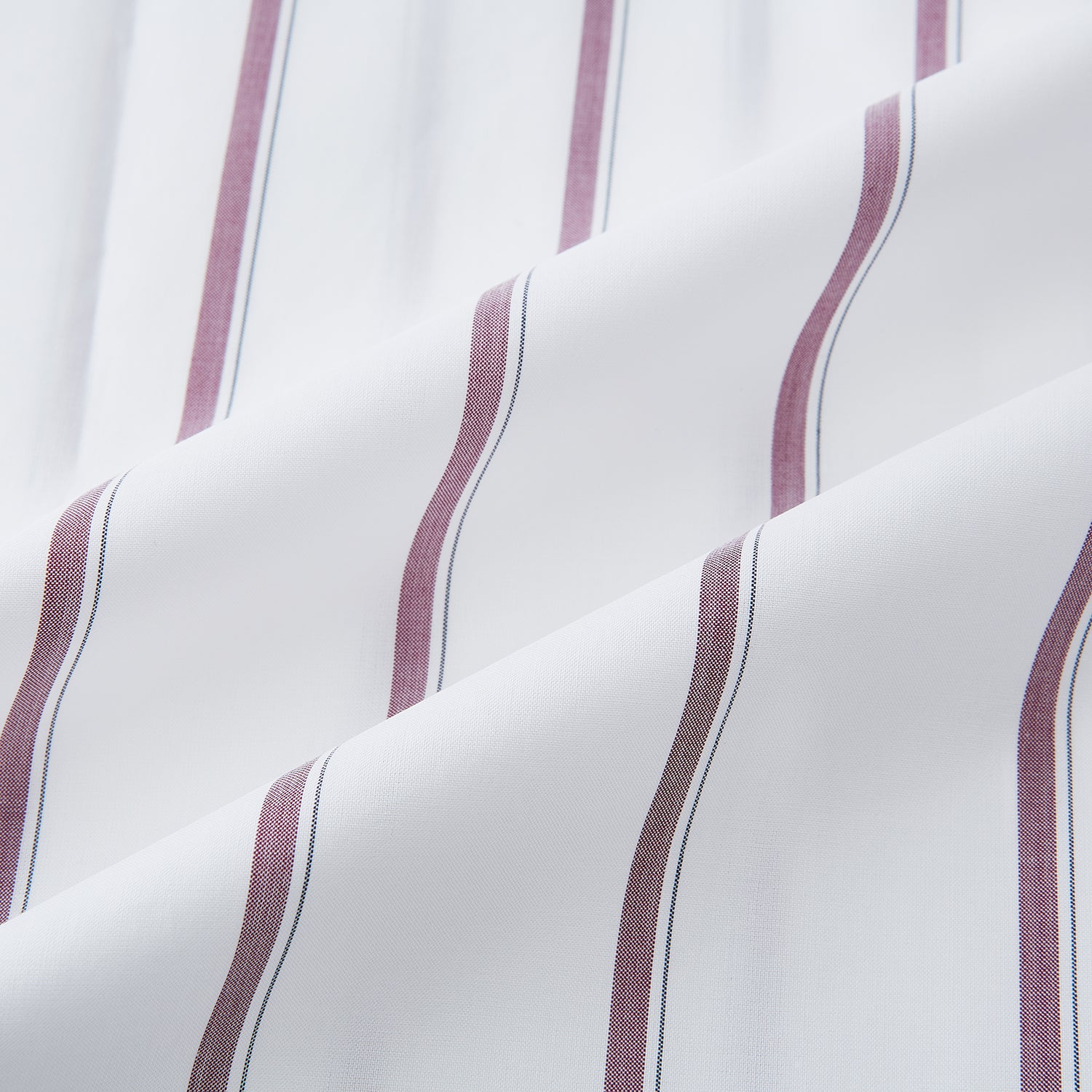 View 6 of product The Turnbull & Asser Wine Track Stripe Mayfair Shirt is a white long-sleeve shirt with vertical wine stripes and a pointed collar, crafted from premium Italian cotton and shown flat against a plain background.