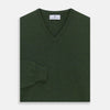 View 3 of product The Turnbull & Asser Green V-Neck Cashmere Jumper, made from soft Scottish cashmere, features long sleeves with ribbed cuffs and a ribbed hem. It is shown laid flat on a white background.