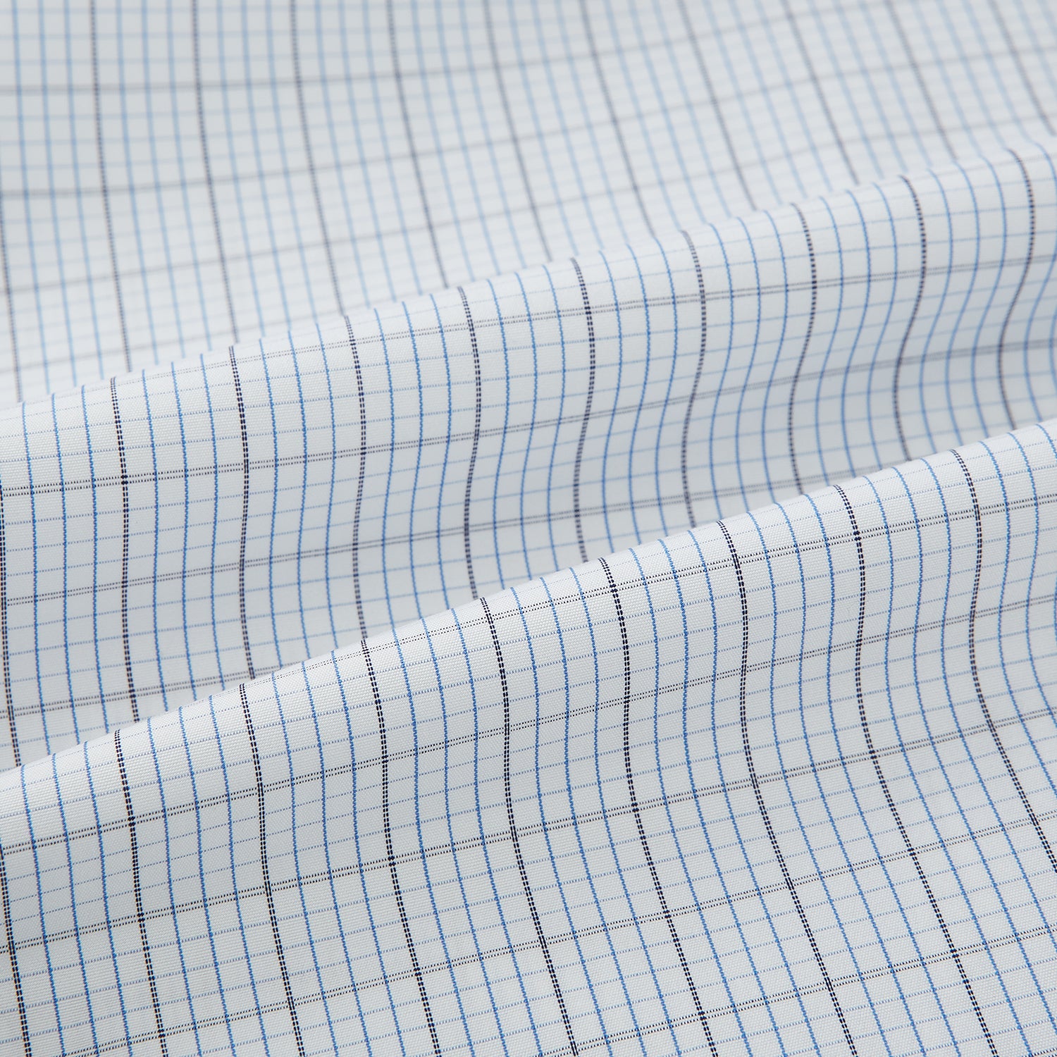 View 6 of product The Turnbull & Asser Navy and Blue Multi Grid Check Mayfair Shirt is a long-sleeve, button-up Italian cotton shirt with a collar and cuffs, featuring a blue grid check pattern, shown against a plain white background.