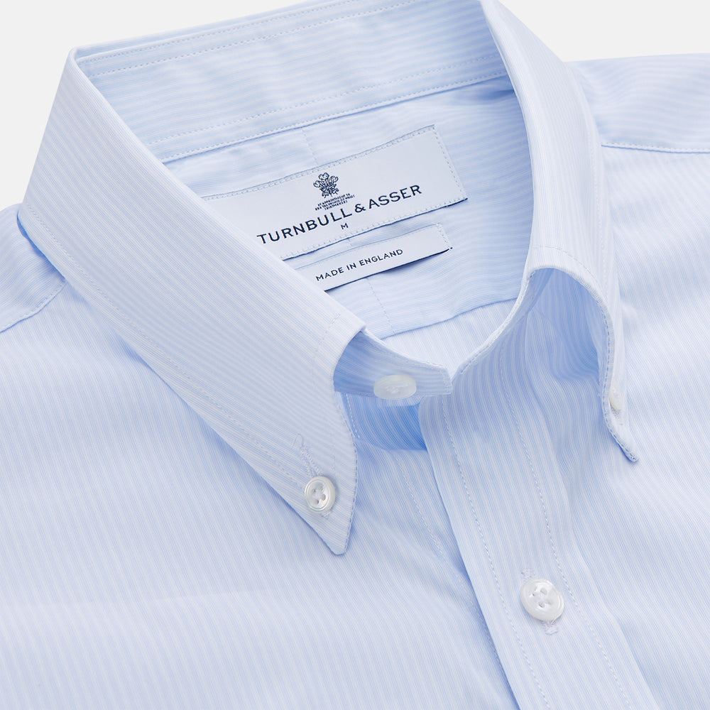 The Turnbull & Asser Pale Blue Stripe Cotton Weekend Fit Williams Shirt features short sleeves, a collar, a single chest pocket, and Italian cotton material, displayed on a plain white background.
