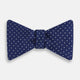 The Turnbull & Asser Azzurro and White Spot Silk Bow Tie features a classic blue silk design with small white spots, shown elegantly against a plain white background.