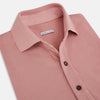 View 2 of product The Turnbull & Asser Red Polo Shirt is a men's cotton polo with short sleeves, a collar, a three-button neckline, and a buttoned chest pocket. The shirt is shown laid flat on a white background.