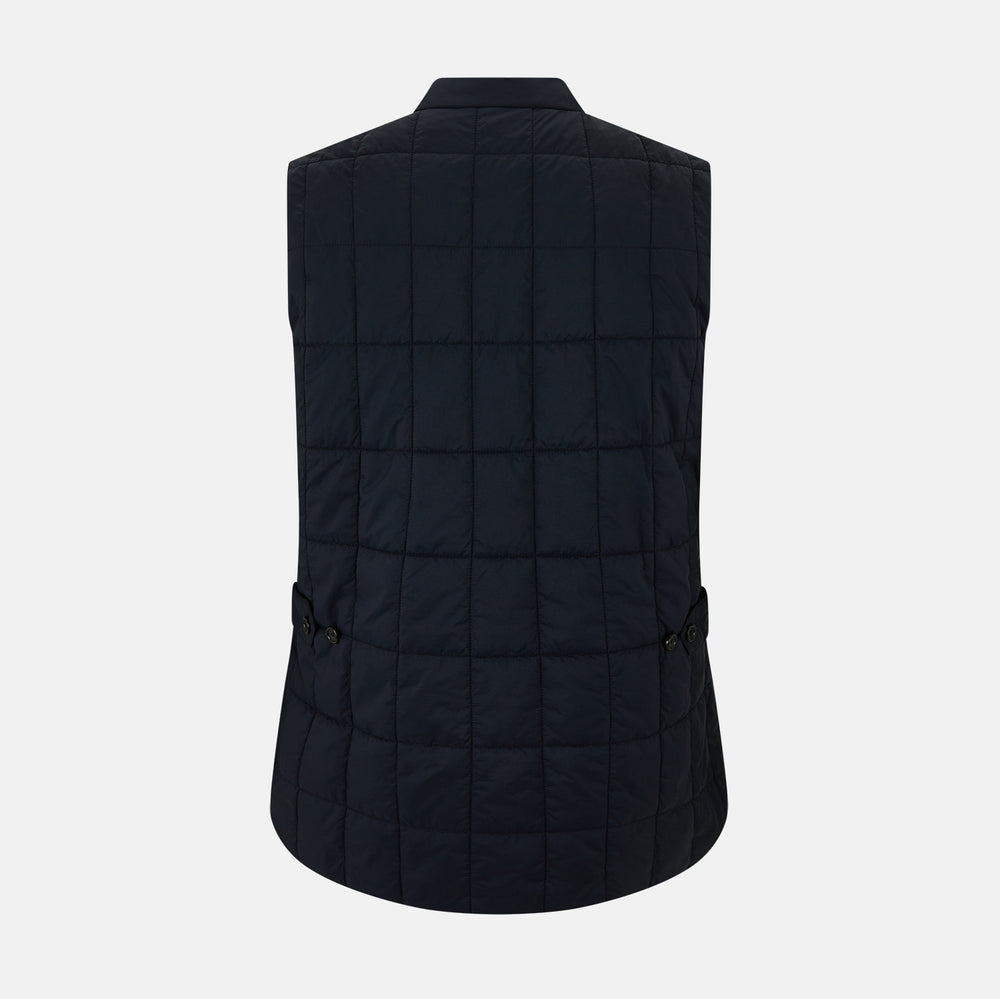 The Turnbull & Asser Navy Quilted Gilet is sleeveless and lightweight, with a front zipper, zippered side pockets, chest pocket, and rounded hem—ideal for versatile layering. Shown on a plain white background.