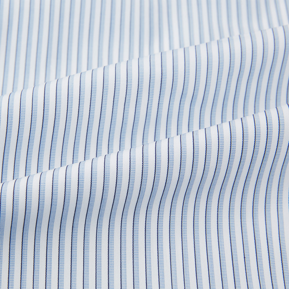 The Turnbull & Asser Sky Blue Shadow Pinstripe Mayfair Shirt, a long-sleeved, button-up shirt with a T&A collar and light blue and white thin vertical stripes, is displayed flat on a white background.