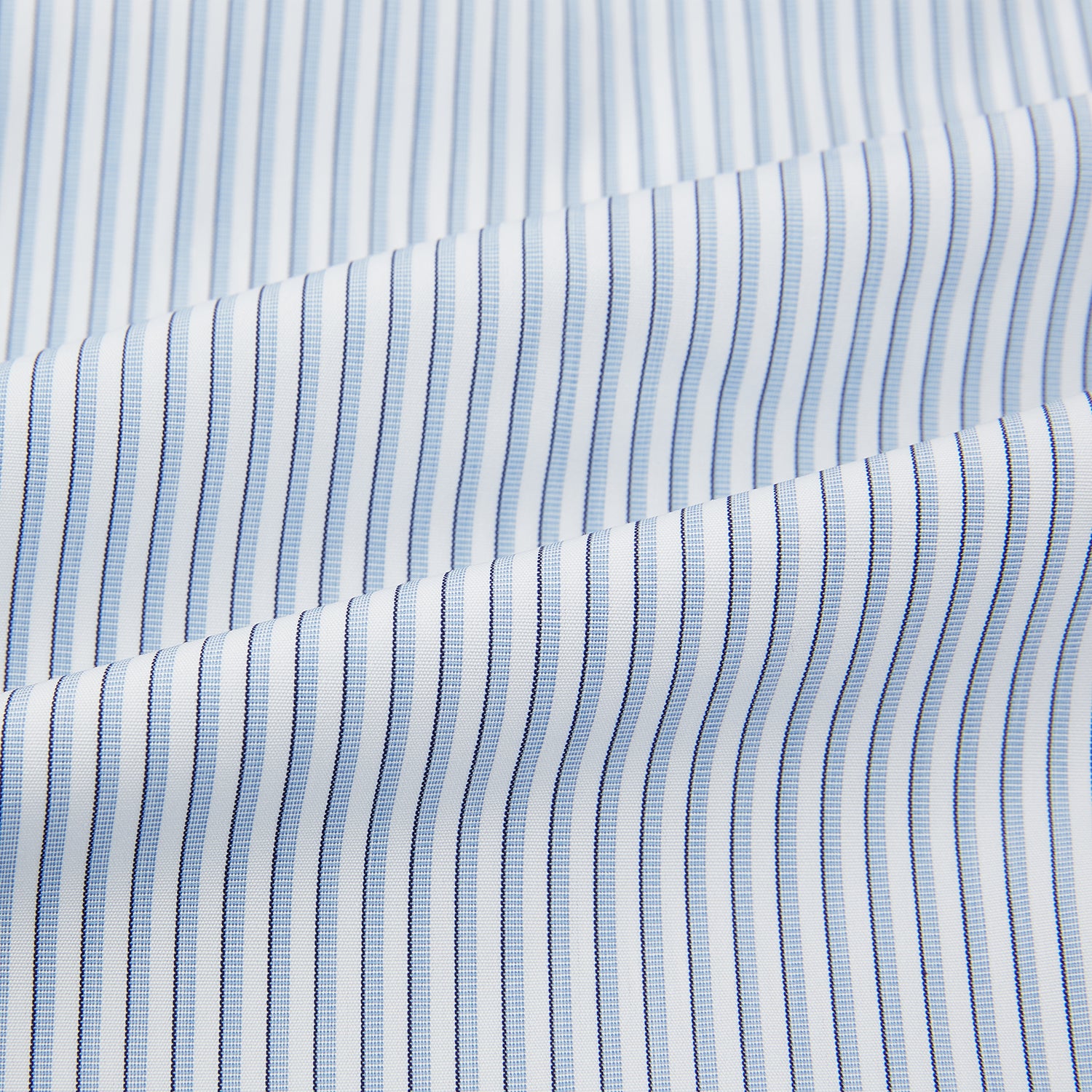 View 6 of product The Turnbull & Asser Sky Blue Shadow Pinstripe Mayfair Shirt, a long-sleeved, button-up shirt with a T&A collar and light blue and white thin vertical stripes, is displayed flat on a white background.